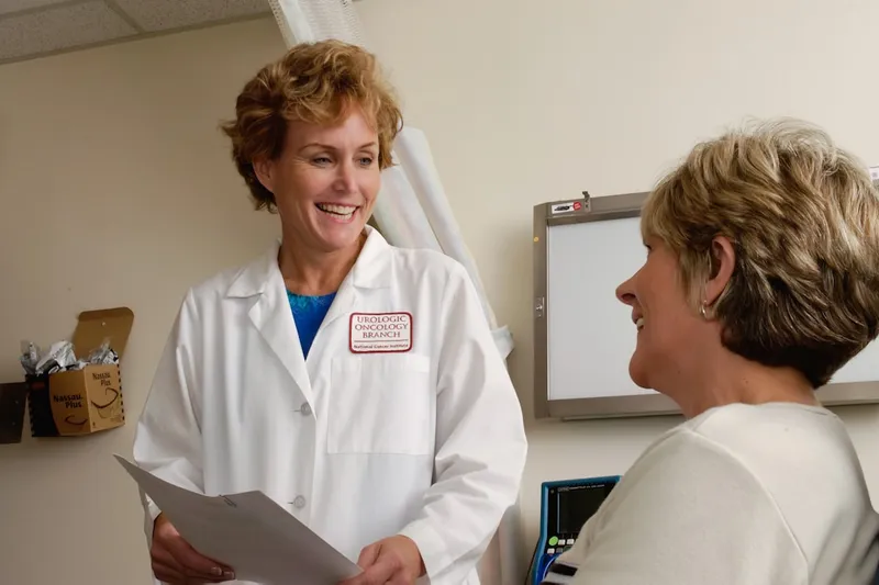 Healthcare professional welcoming a client into a clean clinic room